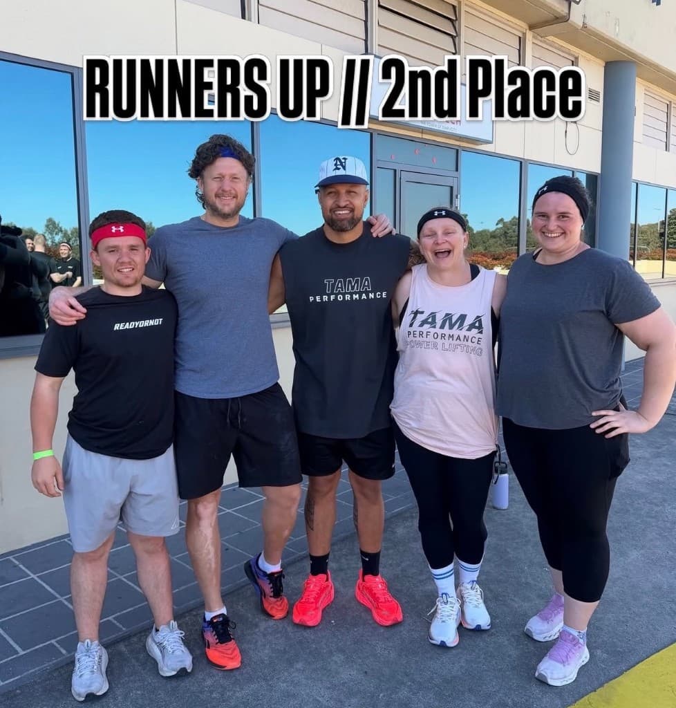 A small group posing after a fitness competition, a runners-up sign overlaid